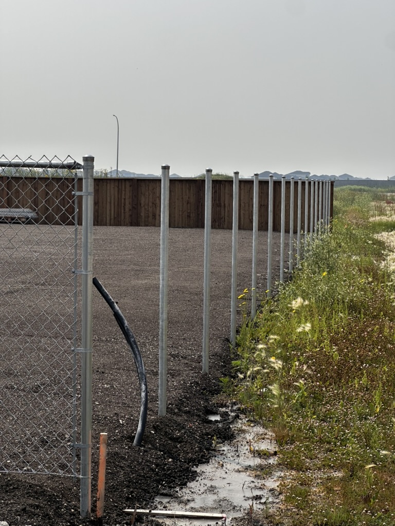 Commercial fence post installation in progress