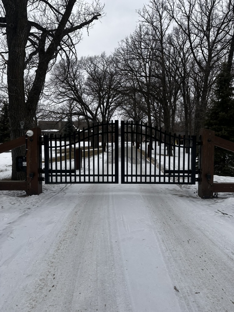 Double swing estate gate between stone pillars
