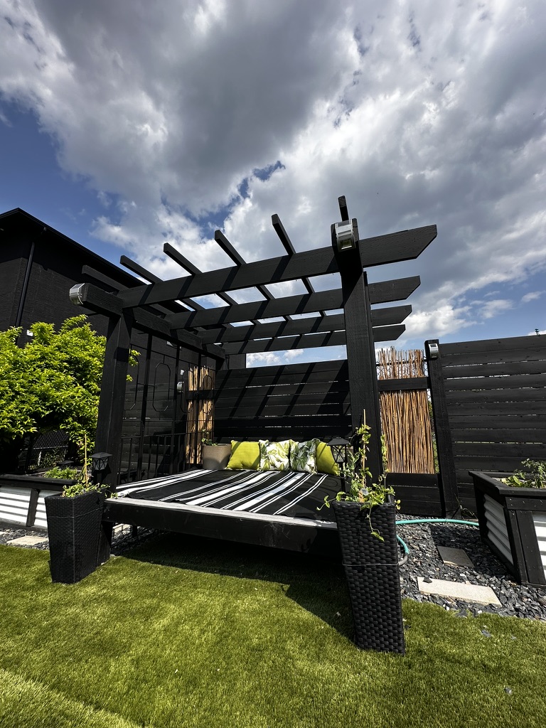 Modern black pergola with horizontal fence